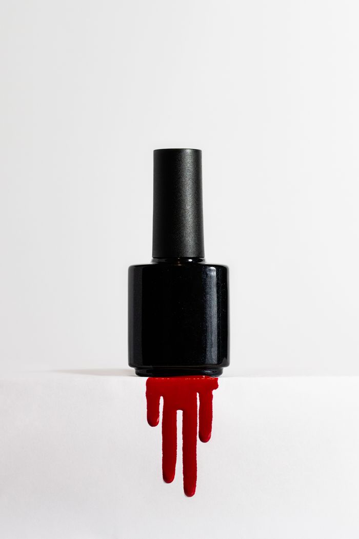 Crafting Captivating Headlines: Your awesome post title goes here Chic black nail polish bottle with striking red drip on a white background, ideal for beauty products.