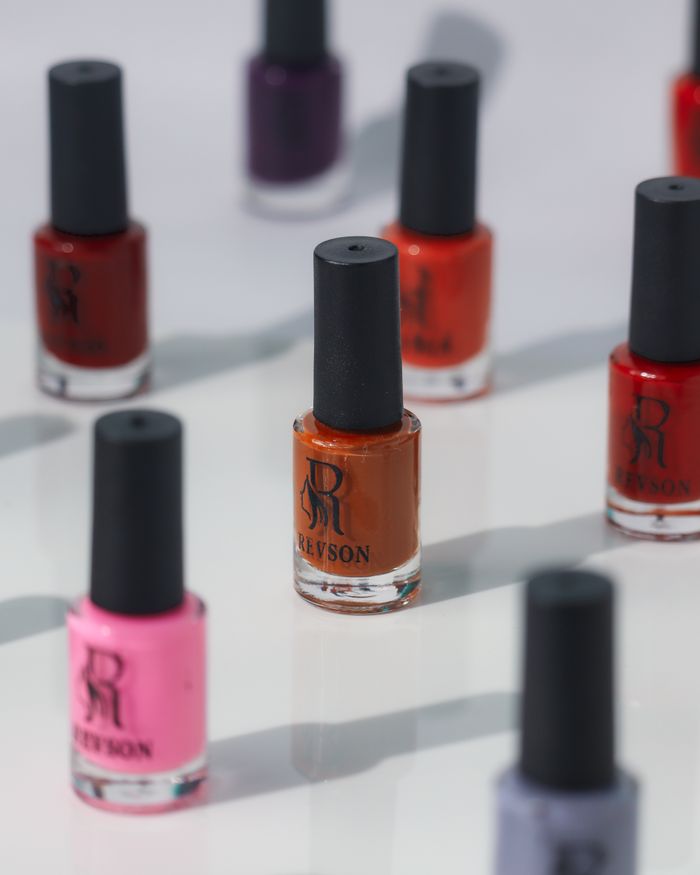 The Art of Drawing Readers In: Your attractive post title goes here Assorted nail polish bottles in vibrant colors arranged on a reflective white surface.